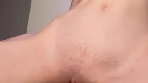 Blonde Spreads for Close-Up Pussy Shots in Blue Light