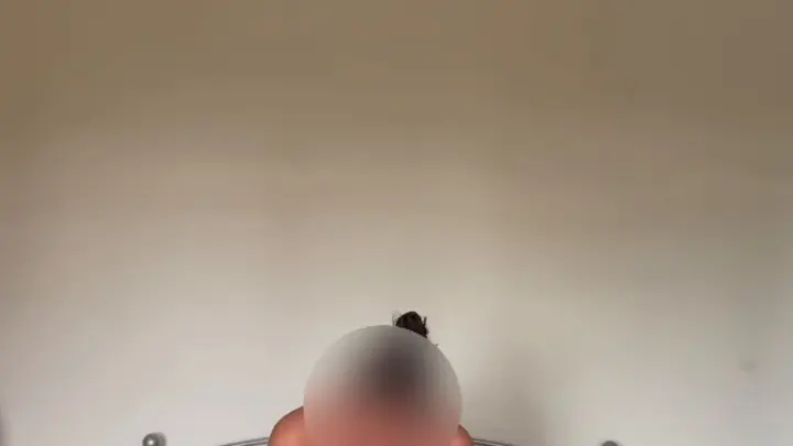 Black woman in bun gives blowjob to white guy with chest hair