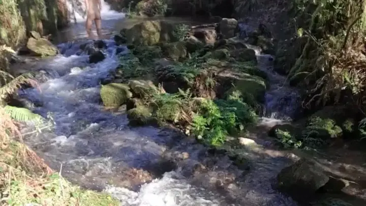 Chica blanca delgada se folla en el río