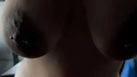 Latina in blue-gray jacket exposes big tits in bed close-ups