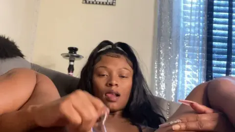 Black curvy girl jerking off on bed with hookah in bedroom