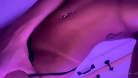 Slim brunette with navel piercing jerking off in bed