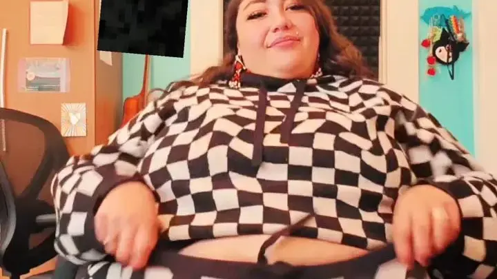 Thick brunette shows off big belly and tits in office chair
