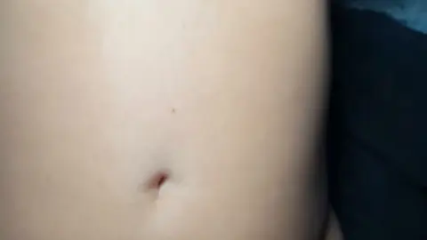 Petite Latina with freckles gives oral on dildo in dim room