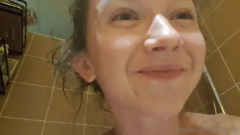 Slim brunette MILF jacks off in shower with big bare tits out