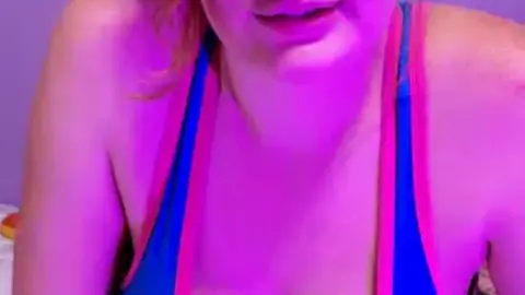 Curvy Caucasian woman with septum piercing and tattoos on bed