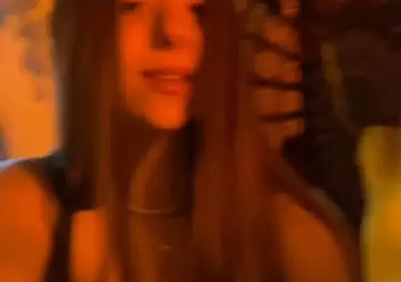 Brunette selfie cam girl shows tits in dim bedroom light