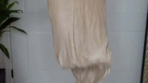 Slim blonde in white socks showcases sheer stockings at home