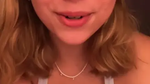 Blonde with spider tattoo teases big cleavage in bedroom