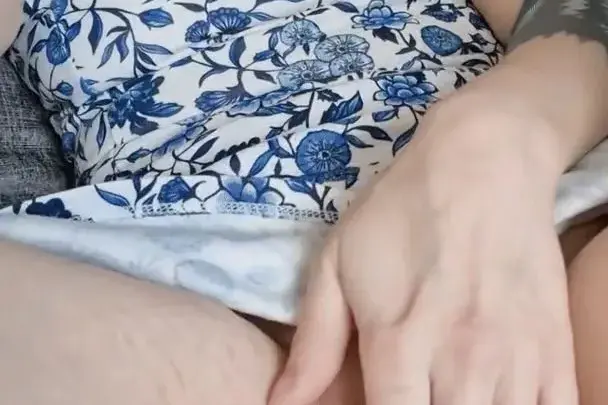 Brunette with stretch marks touches herself on bed, close-up thigh act