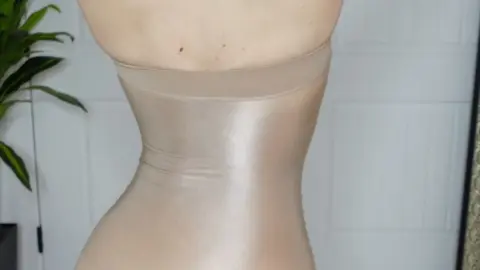 Blonde in nude bodysuit poses and fucks