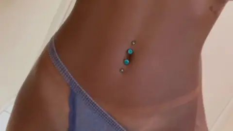 Black girl in light blue underwear poses in bathroom close-ups