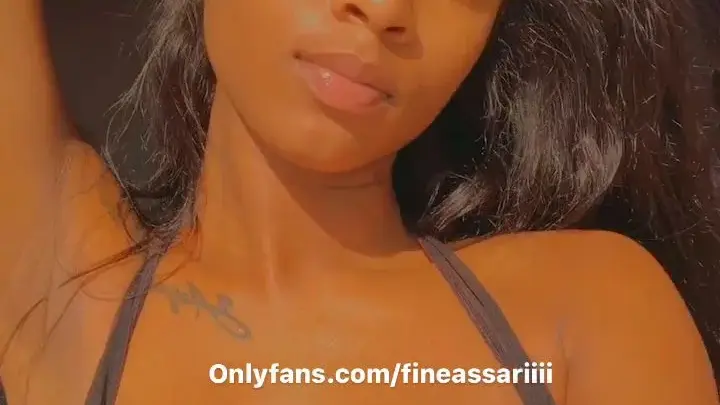 Black curvy girl with tattoos teases bare chest in golden light