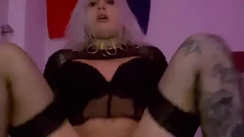 Blonde with tattoos uses dildo on herself in bedroom