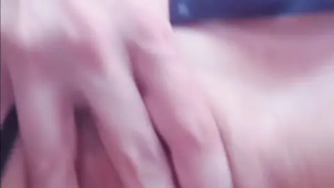 Brunette in blue dress jerking off in bed, POV close-up