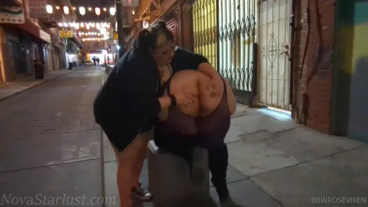 Two curvy mixed brunettes kiss and hug on beach and in alley