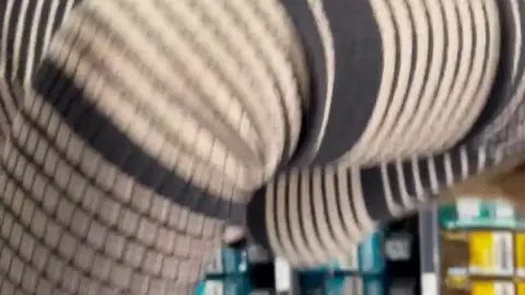 Blonde in pantyhose bends over in store aisle POV