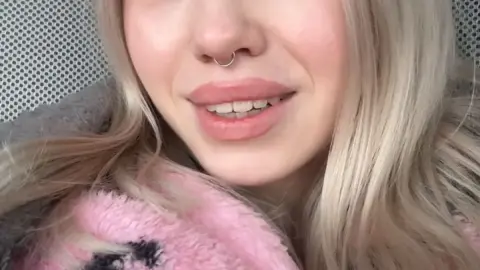 Blonde girl takes selfie close-up