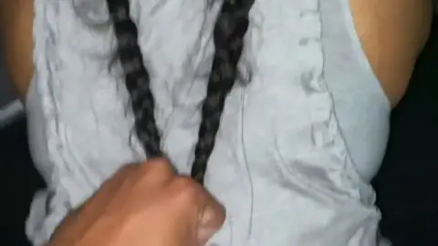 Latina with black braids and tattoo teases ass in bed POV view