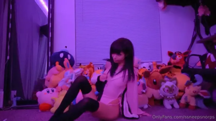 Slim Asian brunette solo posing on floor with phone in purple lit room
